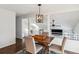 Inviting dining room area with modern lighting and views of the upper level at 9519 Devon Ct, Highlands Ranch, CO 80126