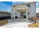Backyard view showcasing covered patio with a seating area and a well-maintained gravel yard at 131 S Vandriver Way, Aurora, CO 80018