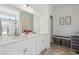 Elegant bathroom with double sinks, white cabinetry, and a glass-enclosed shower at 131 S Vandriver Way, Aurora, CO 80018
