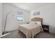 Simple bedroom featuring a cozy bed, a nightstand, a window with blinds and neutral decor at 131 S Vandriver Way, Aurora, CO 80018