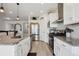 Well-equipped kitchen featuring white cabinetry, granite countertops, stainless steel appliances, and modern fixtures at 131 S Vandriver Way, Aurora, CO 80018