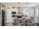 Modern kitchen featuring granite countertops, stainless steel appliances, and a breakfast bar with pendant lighting at 131 S Vandriver Way, Aurora, CO 80018