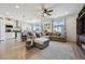 Spacious living room with an open-concept layout, showcasing a large sectional sofa, kitchen and modern appliances at 131 S Vandriver Way, Aurora, CO 80018