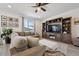 Comfortable living room showcasing a large sectional sofa, a ceiling fan, and a built-in entertainment center at 131 S Vandriver Way, Aurora, CO 80018