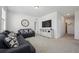 Cozy living room featuring a gray sofa, a large TV, and a decorative console with decorative objects at 131 S Vandriver Way, Aurora, CO 80018