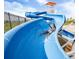 Community water park featuring a large blue water slide for endless fun under the sun at 131 S Vandriver Way, Aurora, CO 80018