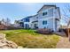 Fenced backyard with manicured lawn, stone walkway, and patio with fire pit at 2881 Black Canyon Way, Castle Rock, CO 80109