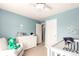 This Bedroom offers a cozy chair, a crib, and a changing table, all bathed in natural light at 2881 Black Canyon Way, Castle Rock, CO 80109