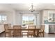 Bright dining area with a wooden table set for six and large windows at 2881 Black Canyon Way, Castle Rock, CO 80109