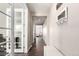 Inviting hallway with wood floors, a decorative mirror, and French doors to a bright office space at 2881 Black Canyon Way, Castle Rock, CO 80109
