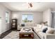 Bright living room featuring a plush sectional sofa, ottoman, and large windows at 2881 Black Canyon Way, Castle Rock, CO 80109