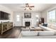 Inviting living room featuring a fireplace, flat-screen TV, comfortable sofa and ceiling fan at 2881 Black Canyon Way, Castle Rock, CO 80109