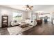 Open-concept living room with sofa, wood floors, and access to dining area at 2881 Black Canyon Way, Castle Rock, CO 80109