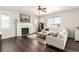 Cozy living room with a fireplace, plush sofa, and a ceiling fan at 2881 Black Canyon Way, Castle Rock, CO 80109
