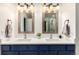 Main bathroom featuring dual sinks, framed mirrors, and updated lights and hardware at 2881 Black Canyon Way, Castle Rock, CO 80109