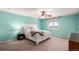 Bright main bedroom with white furniture, ceiling fan, and neutral carpeting at 2881 Black Canyon Way, Castle Rock, CO 80109