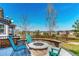 Outdoor patio with stone fire pit and seating with mountain view at 2881 Black Canyon Way, Castle Rock, CO 80109