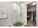 Modern shower with glass doors, rain shower head, and updated tile surround at 2881 Black Canyon Way, Castle Rock, CO 80109