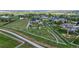An aerial view of the property showcasing the home, tennis courts, and surrounding acreage with white fences at 15355 Zuni St, Broomfield, CO 80023