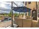Outdoor patio featuring comfortable seating, an umbrella for shade, and views of the pool at 15355 Zuni St, Broomfield, CO 80023