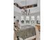 Comfortable bedroom featuring tray ceiling, stylish chandelier, and large windows with countryside views at 15355 Zuni St, Broomfield, CO 80023
