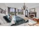 Primary bedroom features a fireplace, chandelier and large windows showcasing beautiful views at 15355 Zuni St, Broomfield, CO 80023
