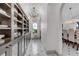 Butler's pantry boasts ample storage, chandelier lighting, and seamless access to the dining area at 15355 Zuni St, Broomfield, CO 80023