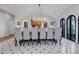 Elegant dining room with chandelier, tile floors and arched windows brings sophisticated charm at 15355 Zuni St, Broomfield, CO 80023
