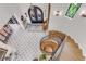 An overhead view of a foyer shows the front door, a sitting bench, marble floors, and a winding wood staircase at 15355 Zuni St, Broomfield, CO 80023