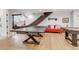 Finished basement with ping pong table, pool table, and red couch with decor at 15355 Zuni St, Broomfield, CO 80023