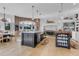 Bright kitchen features butcher block island, breakfast nook, brick accent wall and modern appliances at 15355 Zuni St, Broomfield, CO 80023
