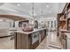 Spacious kitchen featuring a large island, brick accents, and barstool seating, perfect for entertaining guests at 15355 Zuni St, Broomfield, CO 80023