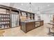 Spacious kitchen featuring a large island, brick accents, and barstool seating, perfect for entertaining guests at 15355 Zuni St, Broomfield, CO 80023