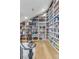 Charming library with a rolling ladder and floor-to-ceiling custom built-in bookshelves for displaying collectibles and books at 15355 Zuni St, Broomfield, CO 80023