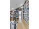 Charming library with a rolling ladder and floor-to-ceiling custom built-in bookshelves for displaying collectibles and books at 15355 Zuni St, Broomfield, CO 80023