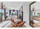 Bright living room featuring hardwood floors, a fireplace, large windows, and stylish chandelier at 15355 Zuni St, Broomfield, CO 80023