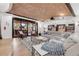 Spacious living room with a brick ceiling, ample seating, and large sliding glass doors to an outdoor patio at 15355 Zuni St, Broomfield, CO 80023