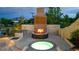 Outdoor living area with a spa, fireplace, and seating area at 15355 Zuni St, Broomfield, CO 80023