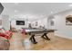 Spacious recreation room with ping pong table, pool table, television, and comfortable seating at 15355 Zuni St, Broomfield, CO 80023