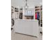 Spacious walk-in closet with custom shelving, storage and a center island at 15355 Zuni St, Broomfield, CO 80023