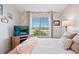 Relaxing bedroom featuring large windows, stylish decor, and comfortable carpeted floors at 474 Black Feather Loop # 419, Castle Rock, CO 80104