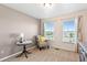 Bright bedroom features two windows with scenic views, chair, and stylish furnishings at 474 Black Feather Loop # 419, Castle Rock, CO 80104