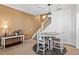 Cozy dining area with modern table, a staircase in the background, and ample natural light at 474 Black Feather Loop # 419, Castle Rock, CO 80104