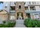 Inviting condo entrance featuring a stone facade, steps leading to the front door, and well-maintained landscaping at 474 Black Feather Loop # 419, Castle Rock, CO 80104