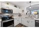 Kitchen area showing updated appliances, fixtures and light countertops at 474 Black Feather Loop # 419, Castle Rock, CO 80104