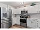 Bright kitchen featuring stainless steel appliances, white cabinetry, and modern fixtures at 474 Black Feather Loop # 419, Castle Rock, CO 80104