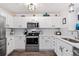 Updated kitchen with stainless steel appliances, white cabinetry, and quartz countertops at 474 Black Feather Loop # 419, Castle Rock, CO 80104