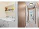 Convenient laundry area with modern washer and dryer, shelving, and easy access to hallway at 474 Black Feather Loop # 419, Castle Rock, CO 80104