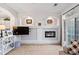 Living room featuring a fireplace, mounted TV, and balcony access at 474 Black Feather Loop # 419, Castle Rock, CO 80104