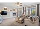 Bright living room with a cozy fireplace, decorative wall features, and a sliding door to the outdoor balcony at 474 Black Feather Loop # 419, Castle Rock, CO 80104